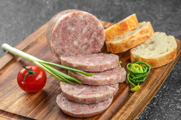 Headcheese chopped. pork meat product on a wooden board, top view. copy space,
