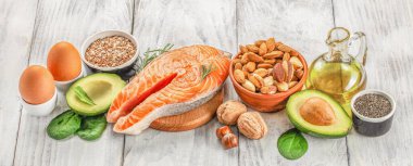 Food sources of omega 3 and healthy fats on a wooden background. top view, clipart