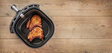 Ahşap bir masada kızarmış domuz bifteği. Uzun afiş biçimi. Üst Manzara. Boşluğu kopyala.