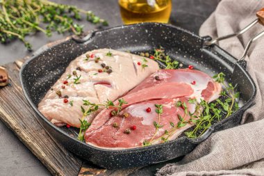 Raw duck meat breast with herbs in pan. Food recipe background. Close up. clipart