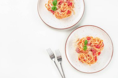 Delicious pasta with tomato sauce, basil and cheese on a light background. top view. copy space, clipart