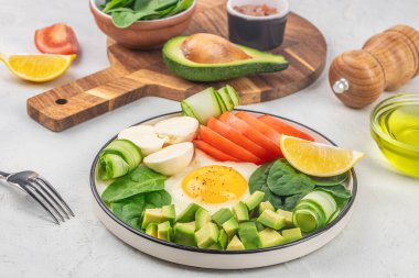 Sağlıklı vejetaryen salatası kahvaltısı ıspanak yaprakları, domates, avokado, peynir ve yumurta. Üst Manzara. Buda kasesi,