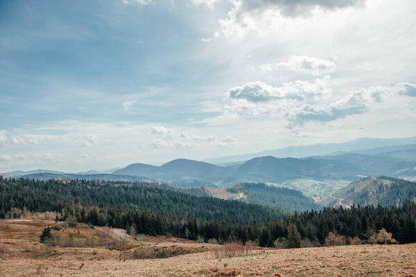 Expansive mountain valley view beneath a dramatic spring sky.