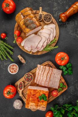 Dilimlenmiş meze, domatesler, otlar, biberler ve tuzla birlikte ahşap tahtalarda güzelce düzenlenerek, sade ve iştah açıcı bir şarküteri görüntüsü yaratılıyor..