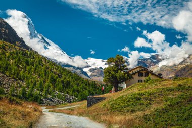 Yüksek sisli Matterhorn tepeleri ve Zermatt, İsviçre, Avrupa yakınlarında yeşil tarlaları olan güzel dağlık yürüyüş patikaları.
