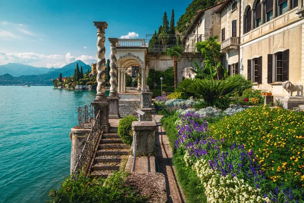 Amazing view from the flowery ornamental garden. Beautiful terrace with colorful flowers in the garden of villa Monastero, lake Como, Varenna, Lombardy, Italy, Europe