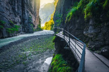 Popular hiking pathway in the Aare gorge. Amazing place with footbridge above the Aare river in the narrow gorge, Meiringen, Switzerland, Europe clipart