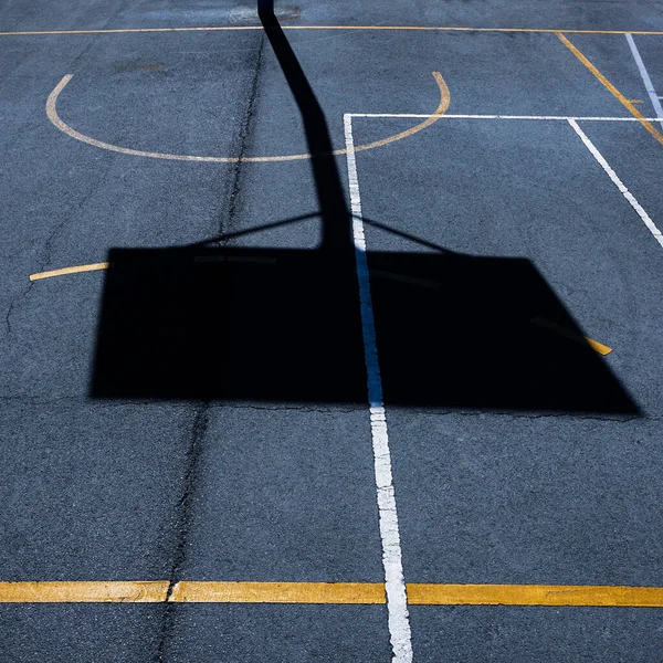 street basketballl hoop shadow on the sports court