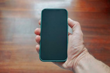 hand holding a smart phone, phone addicted 