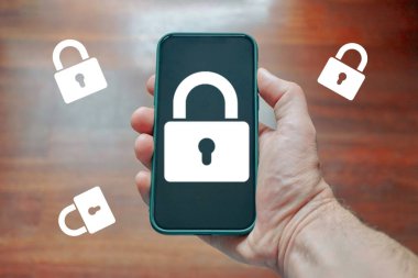 hand holding a phone with a padlock security symbol 