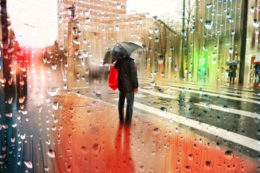 people with an umbrella in rainy days in winter season, bilbao, basque country, spain 