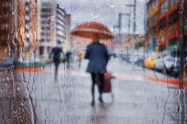people with an umbrella in rainy days in winter season, bilbao, basque country, spain 