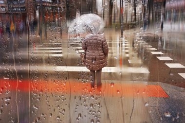 people with an umbrella in rainy days in winter season, bilbao, basque country, spain 