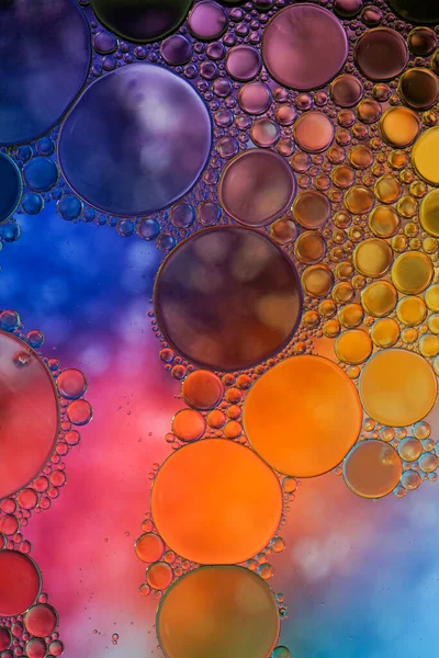 multi colored oil circles on the water, colorful background
