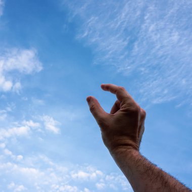 hand up gesturing in the blue sky, feelings and emotions