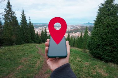 hand holding a smart phone searching location, with a gps symbol  clipart