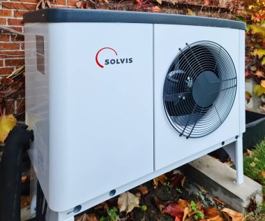 Kiel, Germany - 03 November 2022: A new Solvis brand heat pump shortly at outdoor installation clipart