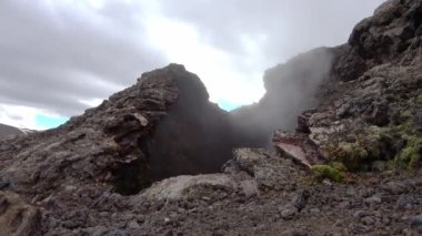 Unreal volcanic landscape in Iceland with steaming rocks on a volcano.