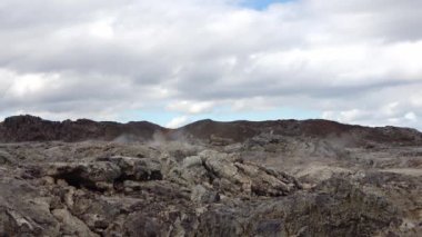 Unreal volcanic landscape in Iceland with steaming rocks on a volcano.