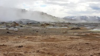Unreal volcanic landscape in Iceland with steaming rocks on a volcano.