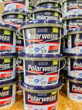 Kiel, Germany - 11 February 2023: Several buckets of white Polarweiss wall paint in a DIY store.