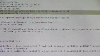 Computer Source Code scrolls on a screen.