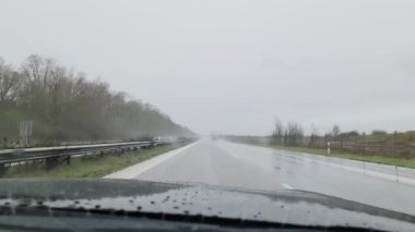 Hamburg, Germany - 19.February 2023: View from the windscreen of a fast-moving car on the motorway in heavy rain