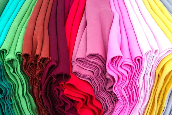 View on samples of cloth and fabrics in different colors found at a fabrics market.