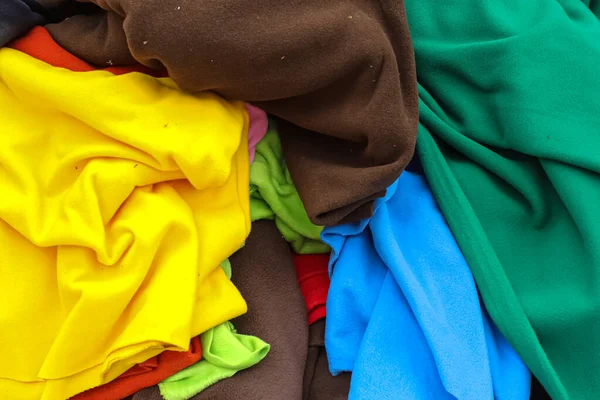 View on samples of cloth and fabrics in different colors found at a fabrics market.