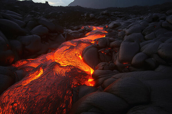 A luminous magma flow in a lava field