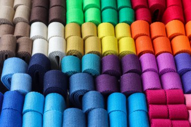 Samples of cloth and fabrics in different colors found at a fabrics market.
