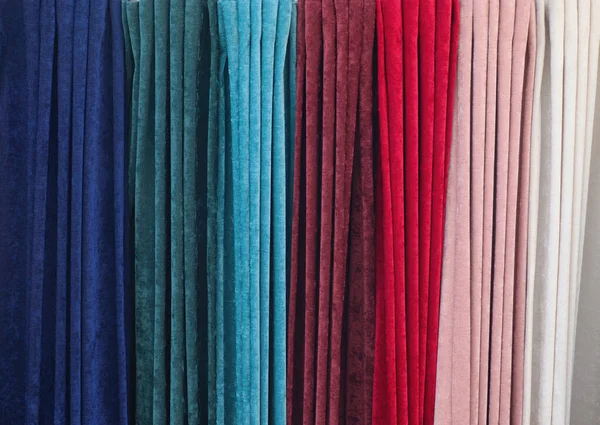 Samples of cloth and fabrics in different colors found at a fabrics market.