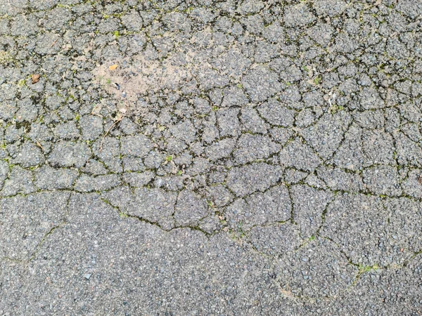 Asphalt surfaces of different streets and roads with cracks