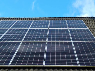 Güneş panelleri bir konutun çatısında temiz enerji üretiyor.