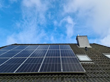 Birçok güneş paneli, bir konut evinin çatısında temiz enerji üretiyor.