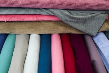 Samples of cloth and fabrics in different colors found at a fabrics market.