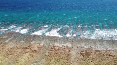 Mercan resiflerinin yukarısından insansız hava aracı görüntüsü ve Maldivler sahillerindeki dalgalar..