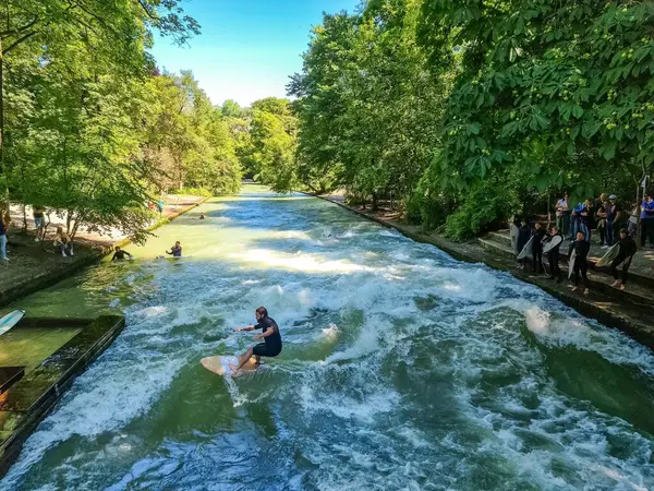 stock image Munich, Germany - 22 June 2024: Surfer at the Eisbach wave in the centre of Munich on the Isar river