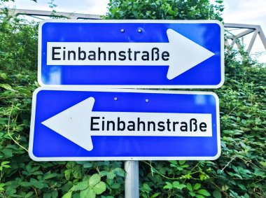 Köln, Almanya - 08 Ağustos 2024: Farklı yönleri gösteren tek yönlü bir cadde için iki işaret