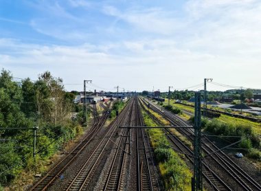 View of the tracks of a freight station with some wagons and numerous sidings clipart