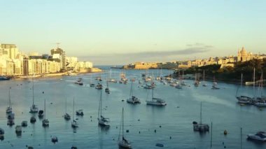 Gün batımında birçok yat ve tekneyle birlikte Malta 'daki Valetta limanında zaman aşımı..