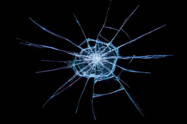 A broken glass window pane on a black background