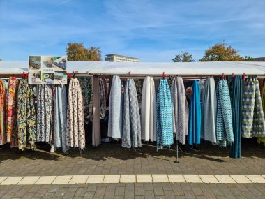 Kiel, Germany - 28. September 2024: Many stalls offering their fabrics for sale in the city center of Kiel clipart