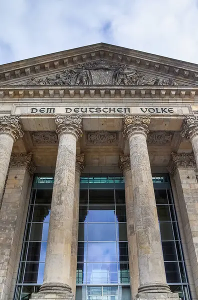 Güneşli bir günde Alman halkına sütunlar ve yazıtlarla Reichstag binasının ön cephesinin alçak açılı görüntüsü