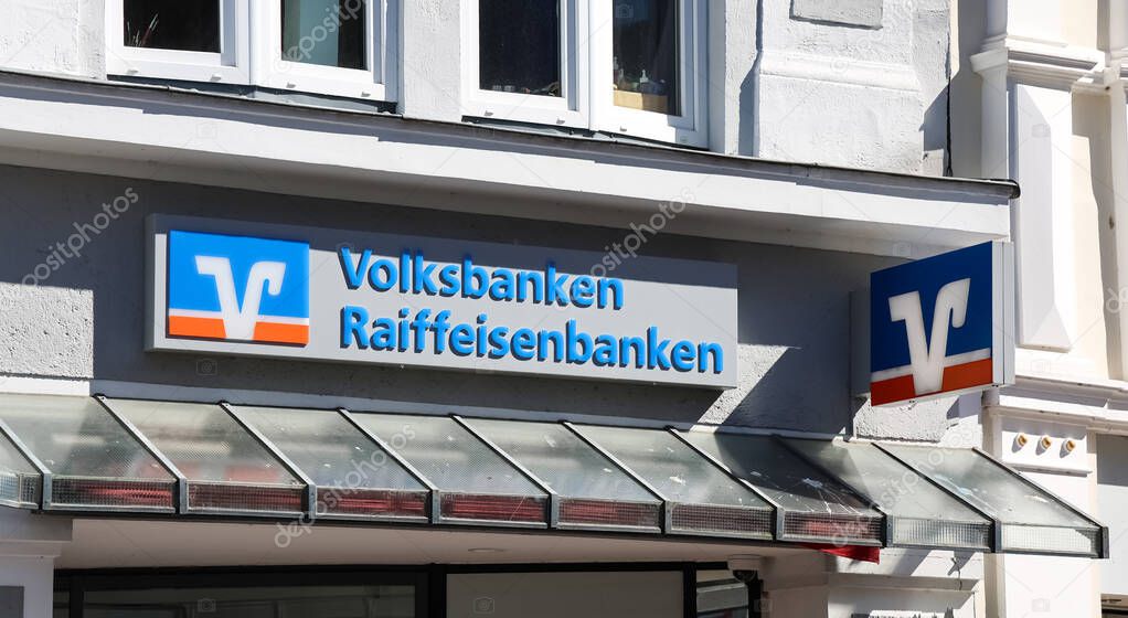 Volksbanken Raiffeisenbanken logo displayed on a building in Flensburg, Germany, representing cooperative financial services