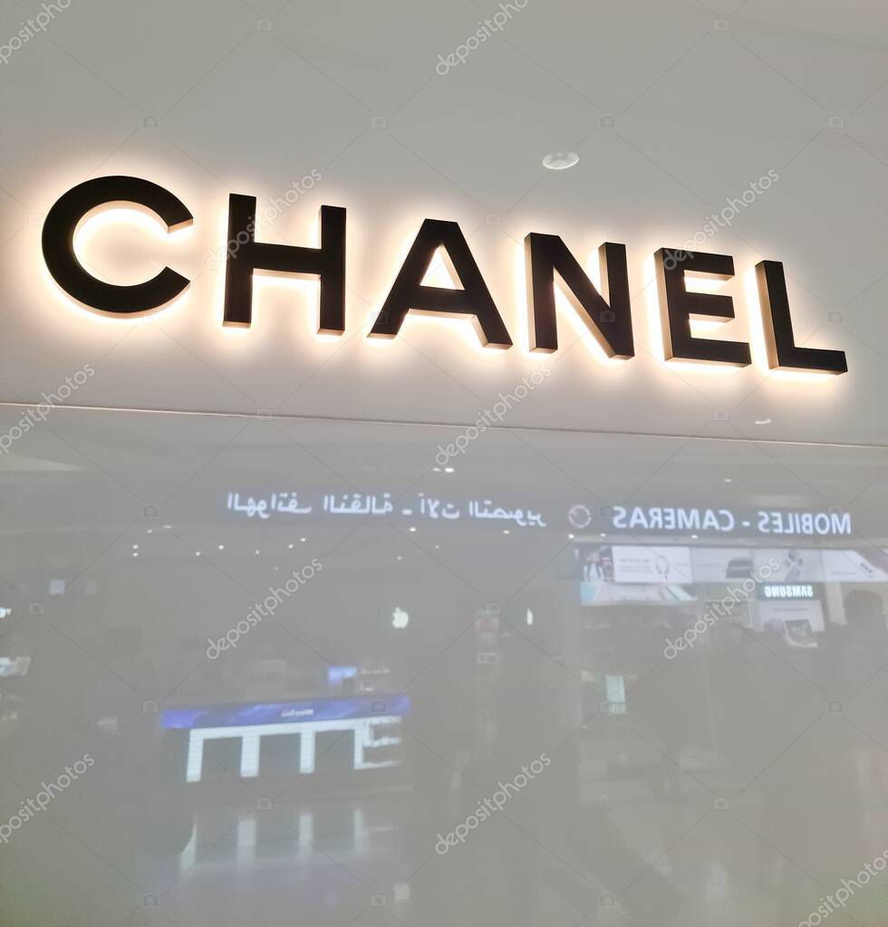 Dubai, United Arab Emirates - 21. January 2024: Close-up of illuminated Chanel logo in Dubai Airport, showcasing luxury branding in a travel retail environment