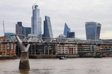 Londra, Birleşik Krallık - 04. Ekim 2024: Thames Nehri üzerinde yükselen modern gökdelenler ve Londra 'daki Millennium Köprüsü, Birleşik Krallık