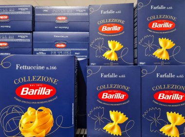 Kiel, Almanya - 05. Mayıs 2025: Fettuccine ve farfalle Barilla makarna kutuları bir süpermarket rafında durgun bir hayat oluşturuyorlar