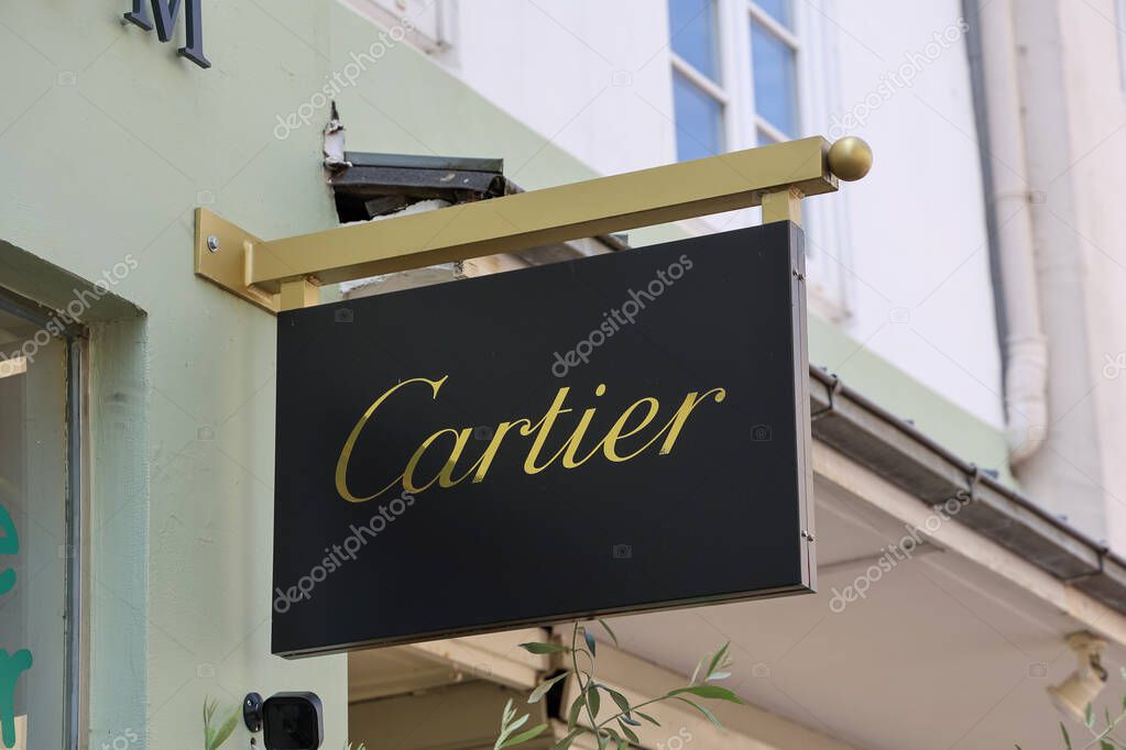 Flensburg, Germany - 13. June 2025: Close-up of Cartier logo on a black and gold store sign in Flensburg, Germany, showcasing luxury brand presence