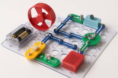 Eğitimsel elektronik devre kiti küçük bir vantilatöre, bir zile ve pilleri kullanarak bir ampule güç veriyor, BTMM öğrenmesini ve deneyini destekliyor.